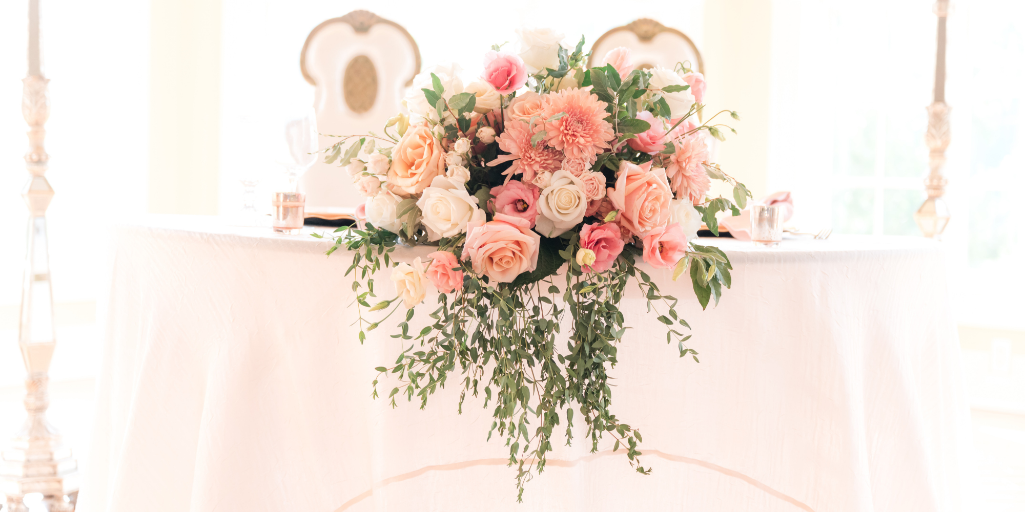 Pink and white rose and daisy wedding floral arrangement 